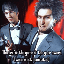 two men in suits and ties are standing next to each other holding awards .