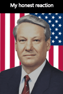 a man in a suit and tie stands in front of an american flag with the words " my honest reaction " below him