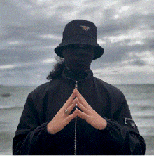 a person wearing a bucket hat and a black jacket