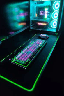 a keyboard and mouse are sitting on top of a green mouse pad next to a computer .