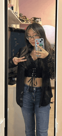 a woman taking a picture of herself in the mirror