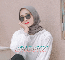 a woman wearing a hijab and sunglasses has the name trenz on the bottom right