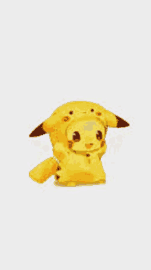 a yellow pikachu is sitting on a white surface .