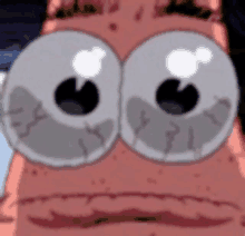 a close up of patrick star 's eyes with a sad look on his face .