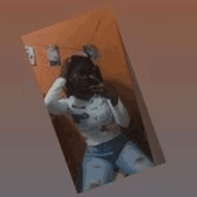 a woman is taking a selfie in the mirror .