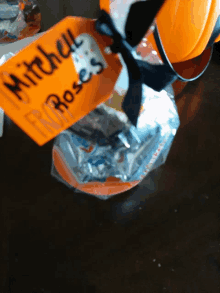 an orange tag with the name mitchell roses on it