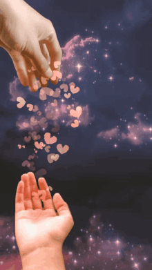 a hand reaching out towards a child 's hand with hearts flying out of it