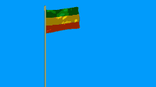 a small flag is waving in the wind against a blue sky