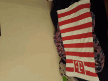 a red and white striped towel with the letters tf on it