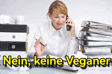 a woman is talking on a cell phone with the words nein keine veganer written below her