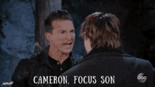 two men are talking to each other with cameron focus son written on the bottom