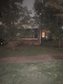 a brick house with a porch and a sign that says ' a ' on it