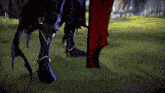 a video game character 's legs are shown standing next to each other in a grassy field