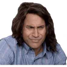 a man with long hair is making a silly face