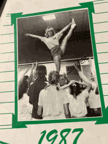 a black and white photo of a cheerleader with the year 1987 on the bottom