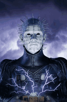 a statue of a man with a spiked head and lightning coming out of his chest