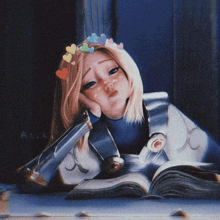 a girl with a crown of hearts on her head is laying on a table reading a book