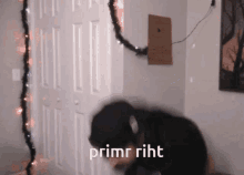 a man wearing headphones stands in front of a door with the words primr riht written on it