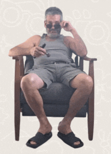 a man sitting in a chair with a pipe in his hand