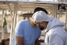 two men are standing next to each other with a photo taken by @sergphotography