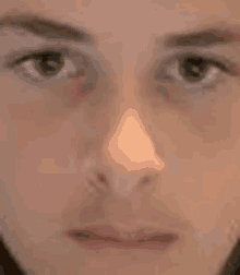 a close up of a person 's face with their eyes closed and their nose visible .