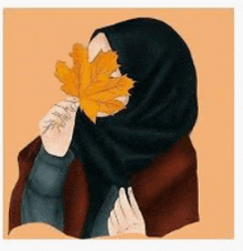 a woman in a hijab is holding a yellow leaf in front of her face .