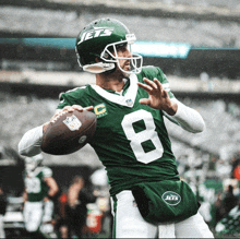 a jets player with the number 8 on his jersey throws a football