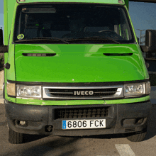 a green iveco truck with a license plate that says 6306 fck