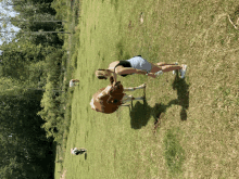 a woman is standing next to a cow in a grassy field