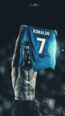 a shirtless soccer player holds up a blue ronaldo 7 jersey