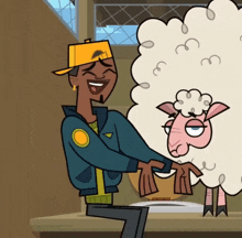 a man in a yellow hat is holding a sheep in his arms