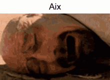 a close up of a person 's face with the word aix written above it