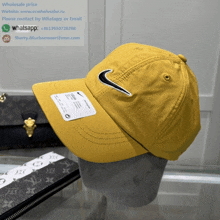 a yellow nike hat is sitting on a mannequin head