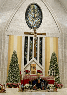 a church with christmas decorations and a nativity scene on the altar