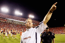 a man wearing a white shirt with auburn written on it