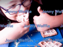 a boy is eating a waffle with the name jonny on it