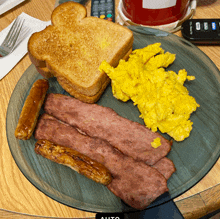 a plate of food with eggs bacon and toast on it