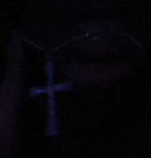 a cross is glowing in the dark with a uv light