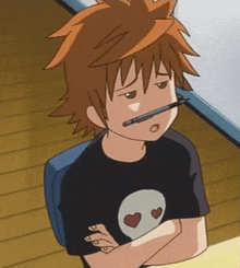 a cartoon boy is sitting at a desk with a pen in his mouth and a skull shirt on .