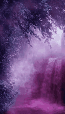 a waterfall in the middle of a purple forest with trees and fog .