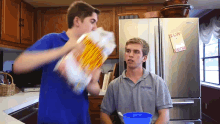 two boys in front of a fridge that has a note on it that says " i love you "