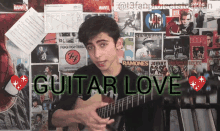 a young man playing a guitar in front of a wall with posters of foo fighters and ramones on it