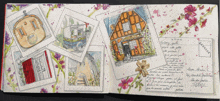 a book is open to a page with drawings of houses and flowers and a postcard from france