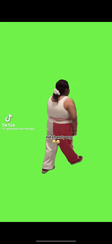 a woman is walking on a green screen in a tiktok video .