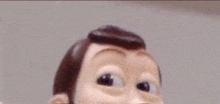 a close up of a woody doll 's face with a blurred background .