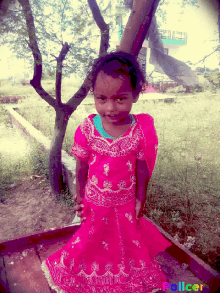 a little girl in a pink dress is standing in front of a tree with the word policer on the bottom