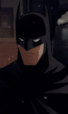 a close up of batman 's face with a serious look on his face