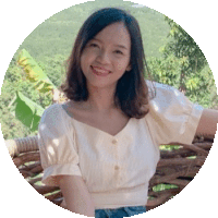 a woman in a white shirt is sitting on a wooden bench .