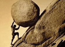 a man is pushing a large rock up a cliff .