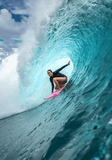 a woman is riding a wave on a surfboard in the ocean